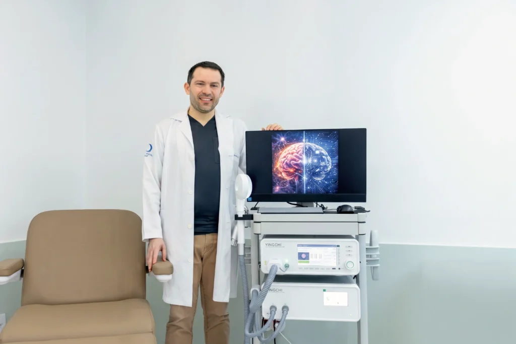 Dr. José Padrão Mendes, neurologista e neuropsiquiatra da Clínica NeuroPsyque, junto a um equipamento de neuromodulação, numa abordagem integrada entre saúde mental e neurologia.